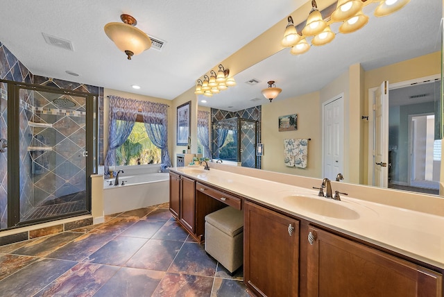 bathroom featuring visible vents, double vanity, a stall shower, a sink, and a garden tub