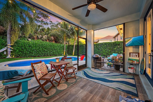 sunroom featuring ceiling fan