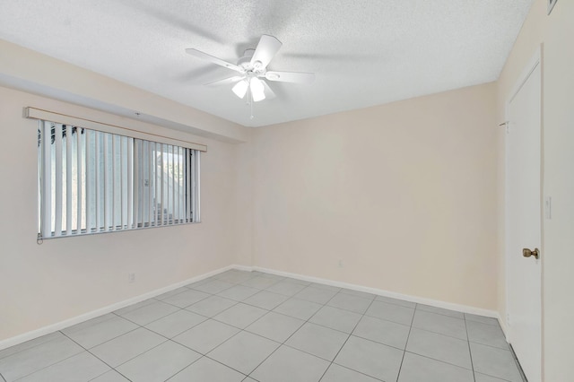 empty room featuring baseboards, a textured ceiling, and ceiling fan