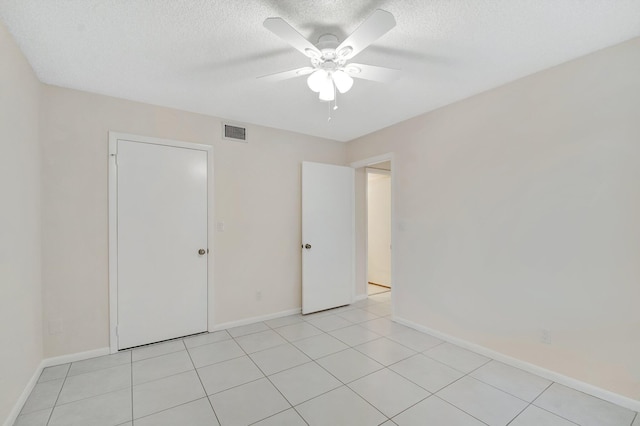 unfurnished bedroom with visible vents, baseboards, a textured ceiling, and a ceiling fan