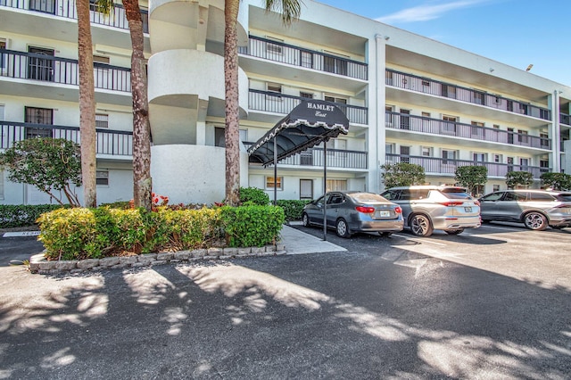 view of building exterior featuring uncovered parking