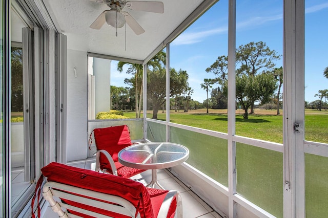 sunroom featuring ceiling fan