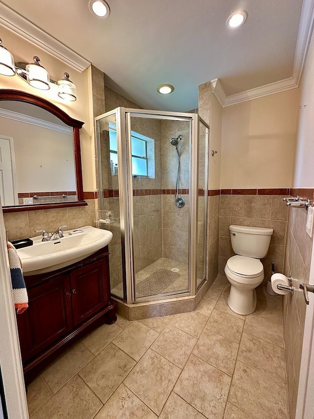 bathroom with a wainscoted wall, tile walls, a stall shower, and ornamental molding