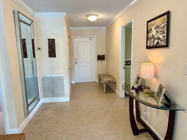 corridor featuring visible vents, baseboards, a textured ceiling, and ornamental molding