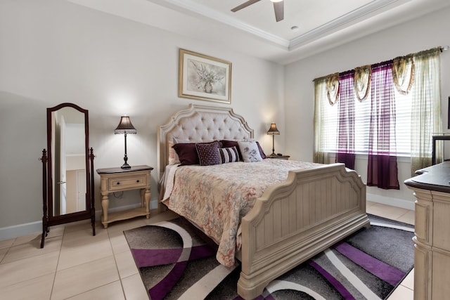 bedroom with baseboards, a tray ceiling, crown molding, and light tile patterned floors