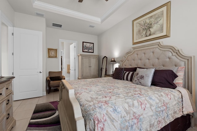 bedroom featuring light tile patterned flooring, ornamental molding, visible vents, and a raised ceiling