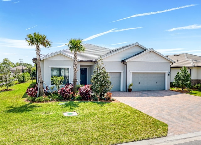 ranch-style home with a front lawn, decorative driveway, a garage, and stucco siding