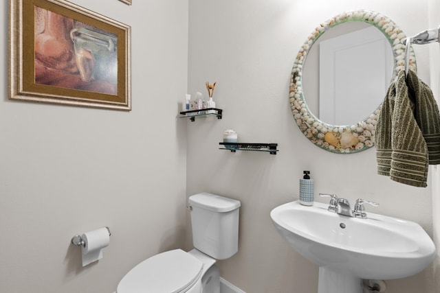 half bathroom with toilet and a sink