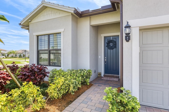 view of exterior entry featuring stucco siding