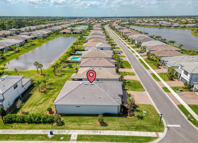 drone / aerial view featuring a water view and a residential view