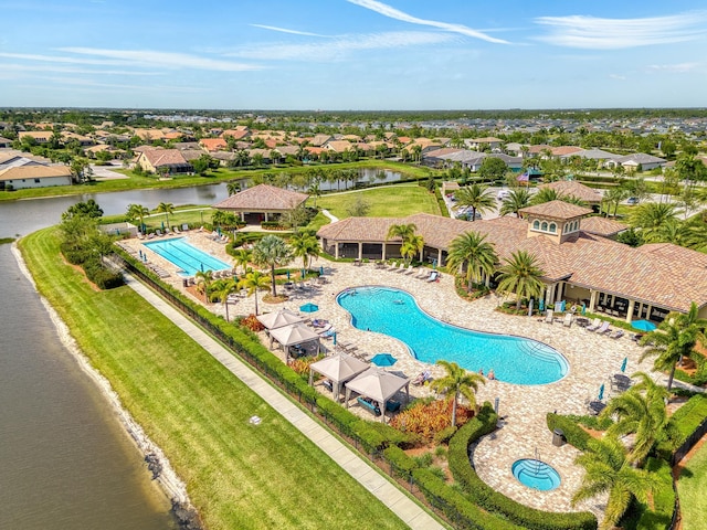 birds eye view of property with a residential view and a water view