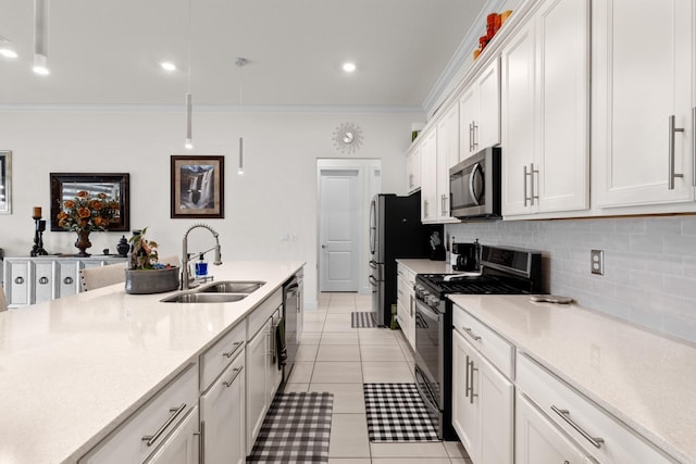 kitchen with decorative backsplash, a sink, appliances with stainless steel finishes, and crown molding
