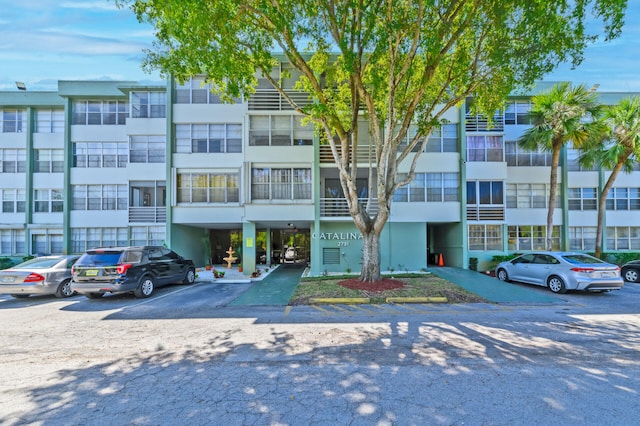 view of property featuring uncovered parking