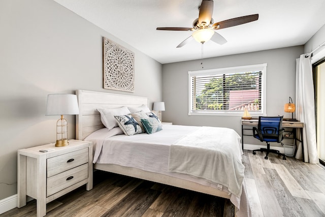 bedroom featuring ceiling fan, baseboards, and wood finished floors