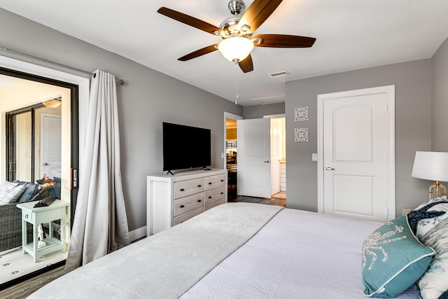 bedroom with wood finished floors, visible vents, and ceiling fan