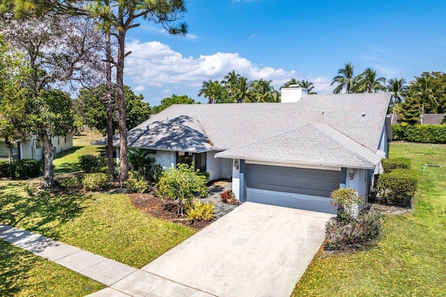 ranch-style house featuring a garage, stucco siding, a front yard, a shingled roof, and driveway