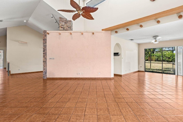spare room with light tile patterned floors, baseboards, a ceiling fan, and lofted ceiling
