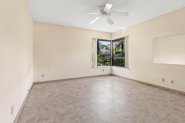 unfurnished room with a textured ceiling, baseboards, and a ceiling fan