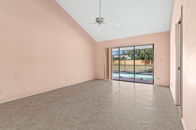 spare room with high vaulted ceiling, baseboards, and a ceiling fan