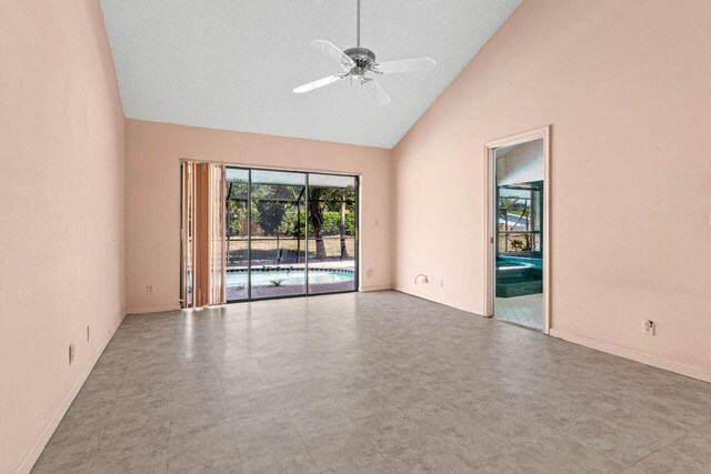unfurnished room featuring ceiling fan, high vaulted ceiling, and baseboards