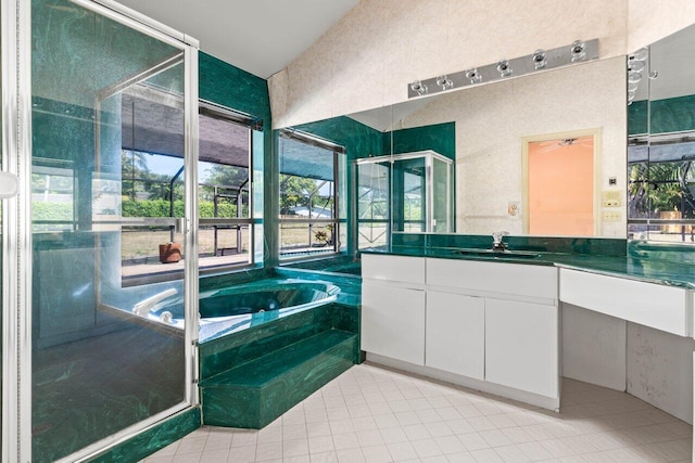 full bathroom with tile patterned floors, vanity, a shower with door, and a garden tub