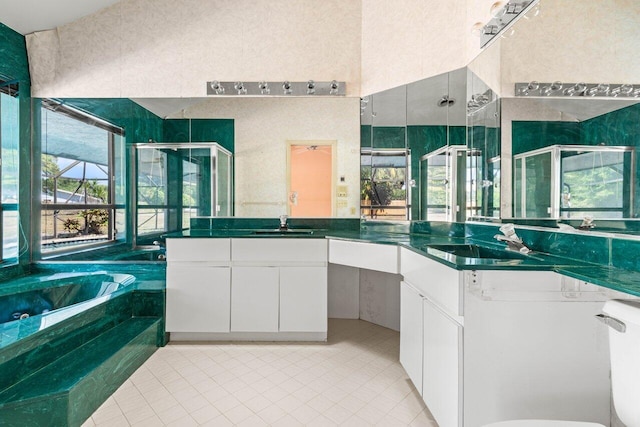 full bath with tile patterned floors, a bath, and a stall shower