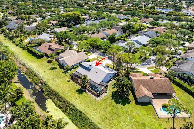 drone / aerial view with a water view and a residential view