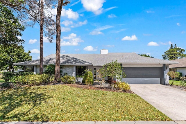 ranch-style house featuring a garage, a front lawn, a chimney, a shingled roof, and concrete driveway