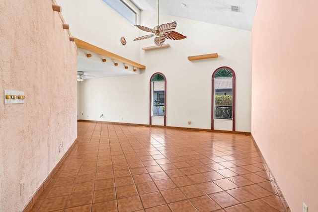 unfurnished room with high vaulted ceiling, ceiling fan, tile patterned flooring, and visible vents