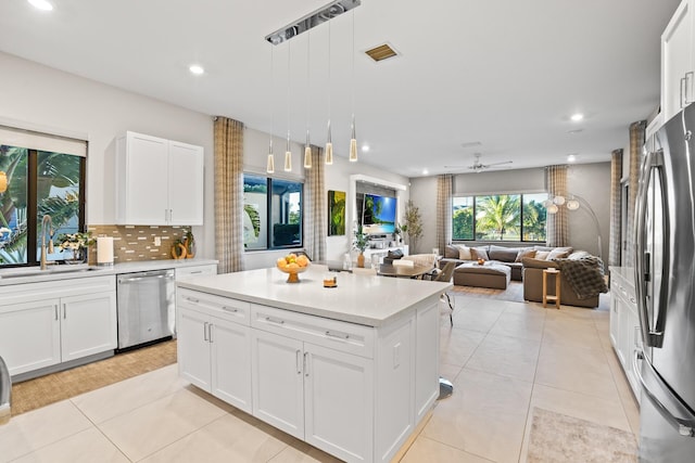 kitchen with light countertops, recessed lighting, appliances with stainless steel finishes, and a sink