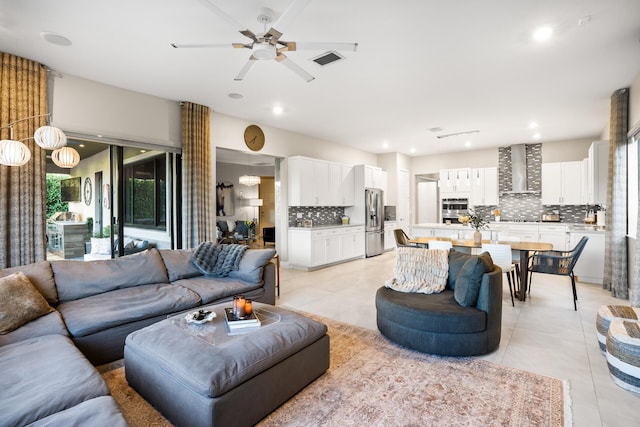 living room featuring light tile patterned floors, a ceiling fan, recessed lighting, and visible vents