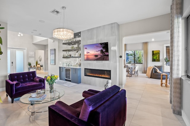 living room featuring beverage cooler, visible vents, a large fireplace, and light tile patterned flooring