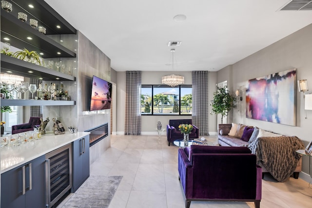 bar with indoor wet bar, beverage cooler, visible vents, and a chandelier