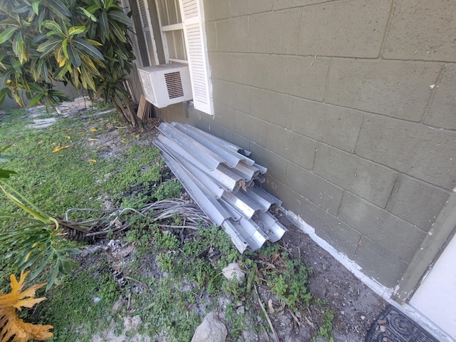 details featuring concrete block siding and cooling unit