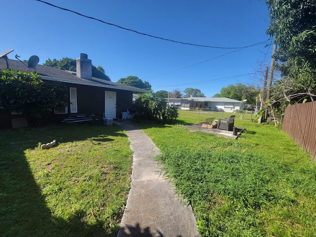 view of yard featuring a patio and fence