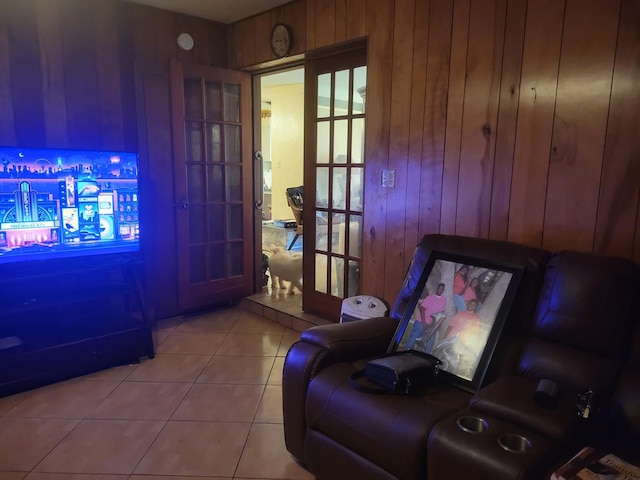 interior space with tile patterned floors and wood walls