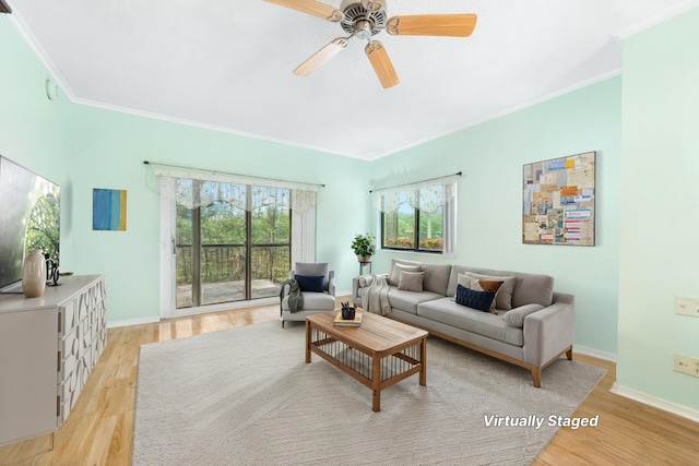 6941 SE Constitution Blvd Unit 101, Hobe Sound, FL 33455 - living room featuring light wood-style flooring, crown molding, ceiling fan, and baseboards