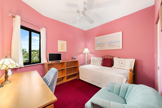 bedroom featuring ceiling fan and dark carpet