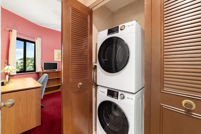 laundry room featuring laundry area, carpet flooring, and stacked washing maching and dryer