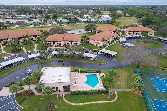 6941 SE Constitution Blvd Unit 101, Hobe Sound, FL 33455 - aerial view of property and surrounding area featuring a nearby body of water, a pool, and nearby suburban area
