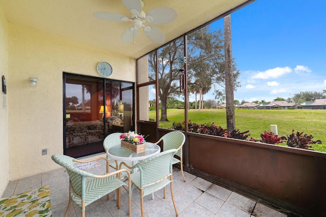 sunroom / solarium with a ceiling fan