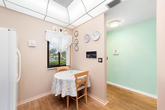 6941 SE Constitution Blvd Unit 101, Hobe Sound, FL 33455 - dining area featuring light wood-type flooring and baseboards