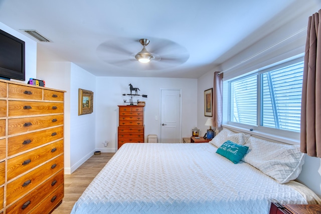 bedroom with ceiling fan, baseboards, visible vents, and light wood-type flooring