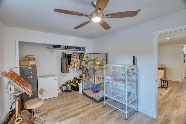 miscellaneous room with ceiling fan, visible vents, baseboards, and wood finished floors