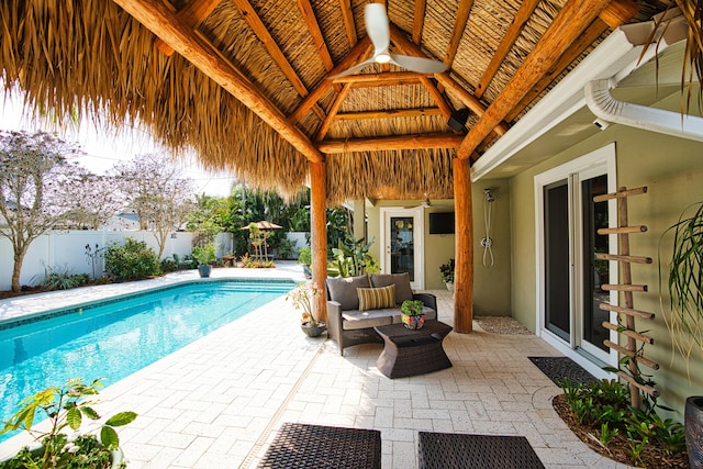 view of swimming pool featuring outdoor lounge area, a patio, a fenced backyard, and a fenced in pool