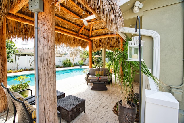 view of patio / terrace with a gazebo, a fenced in pool, and fence