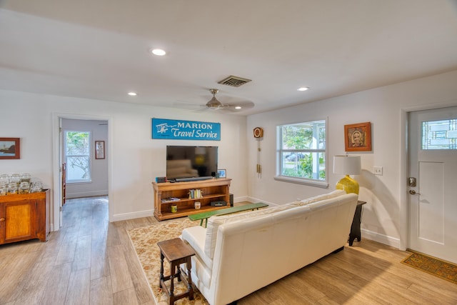 living area with light wood-style flooring, recessed lighting, visible vents, and baseboards