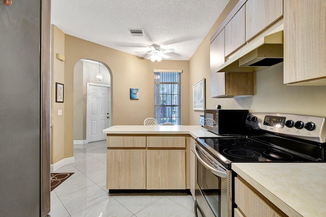 kitchen with light countertops, a peninsula, light brown cabinets, and stainless steel range with electric cooktop