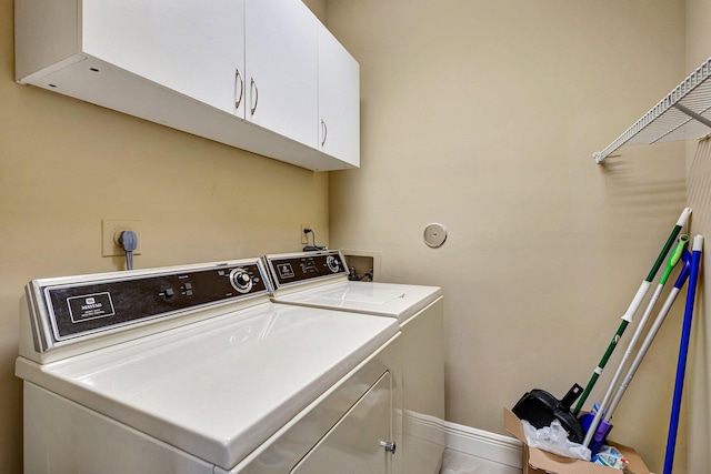 washroom featuring cabinet space and washing machine and dryer