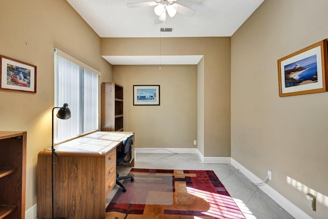 home office featuring visible vents, baseboards, and a ceiling fan